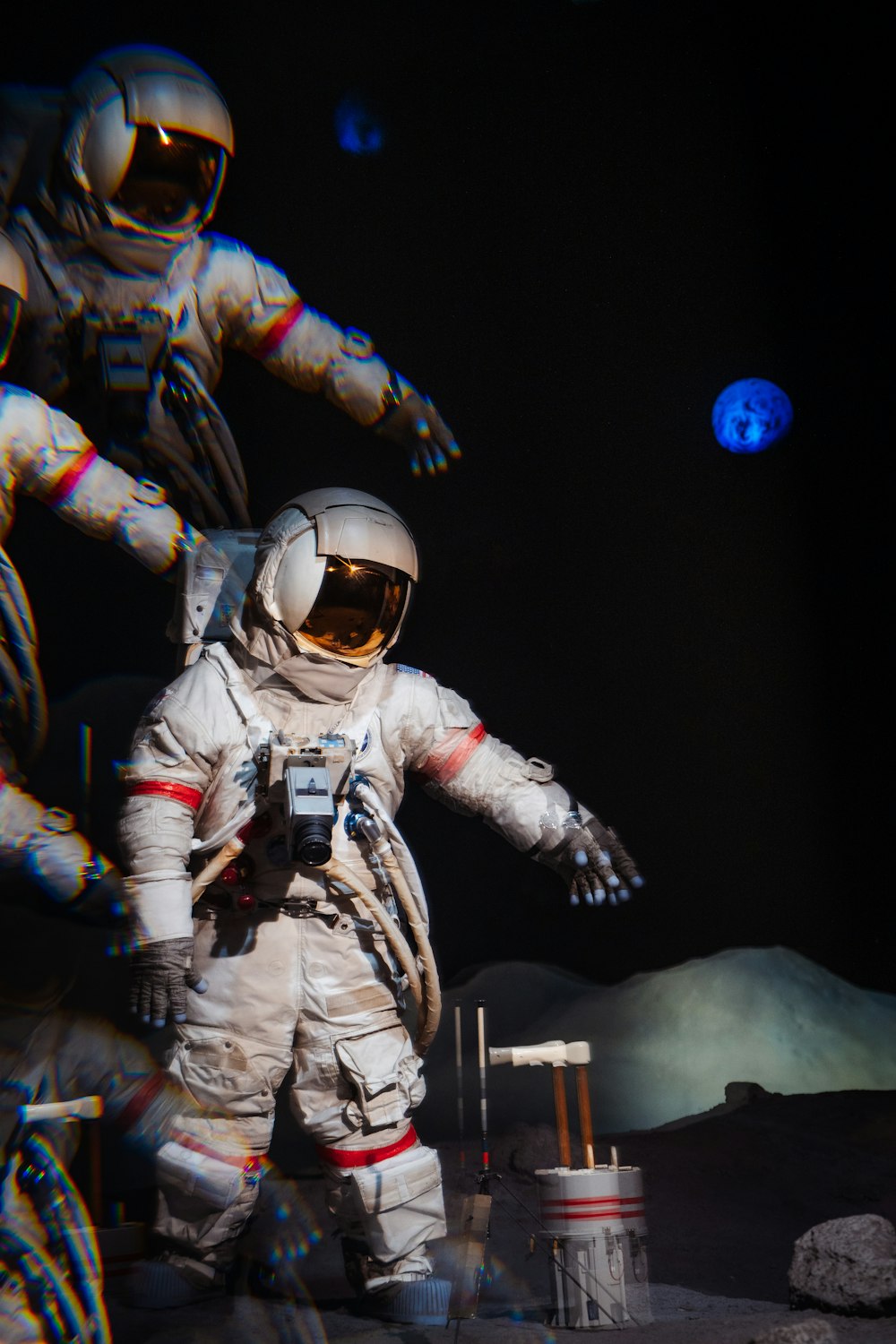 a man in a space suit standing next to another man
