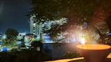 Evening exterior view of Sarangpur Trust Dharmshala glowing under soft lights.