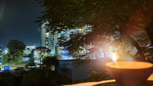 A peaceful evening scene with flickering diyas illuminating the temple courtyard.