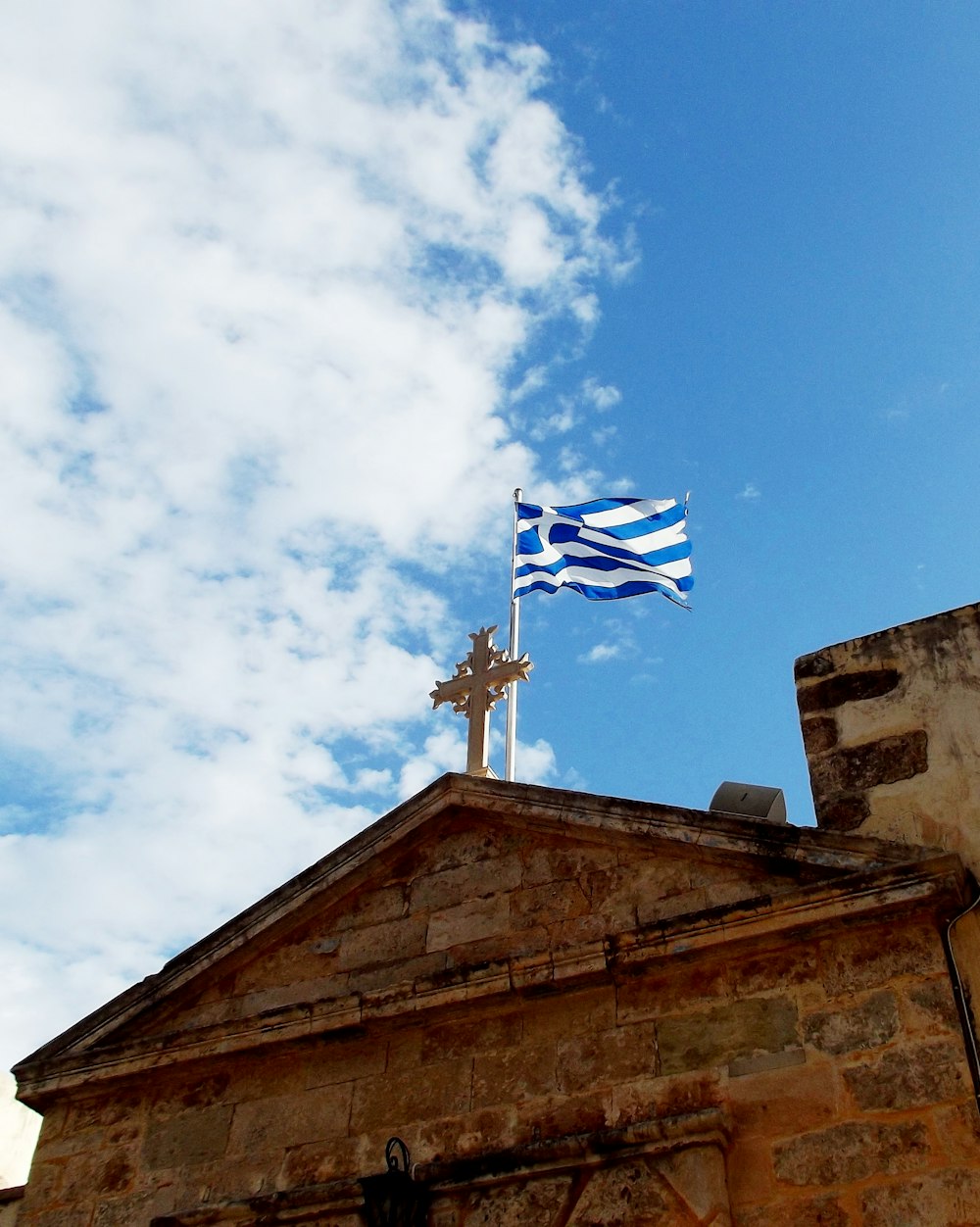 a flag flying on top of a stone building