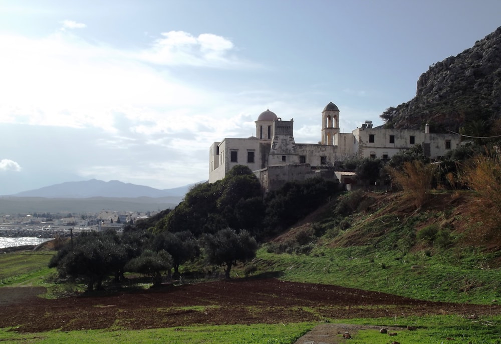 an old church on a hill overlooking a body of water