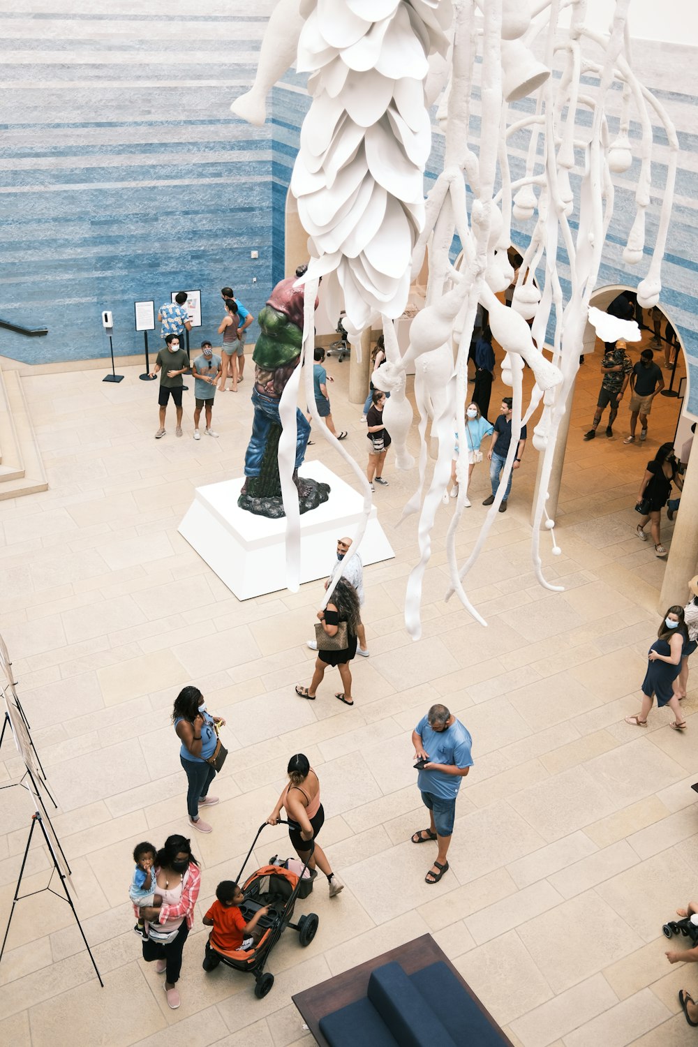 a group of people standing around a sculpture