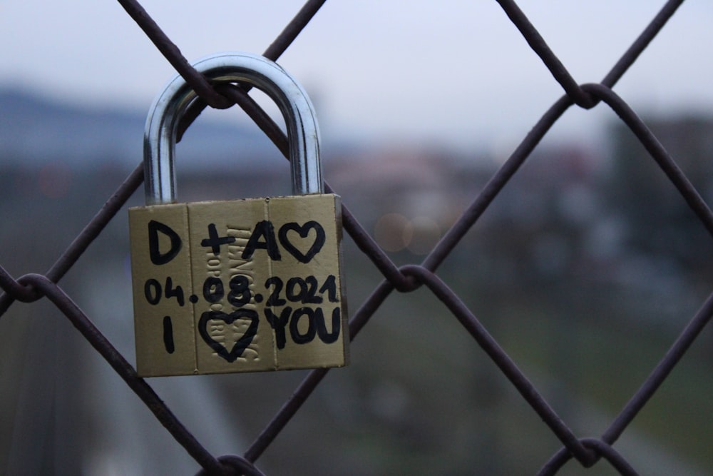 a padlock attached to a chain link fence