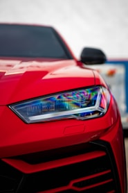 a close up of the front of a red sports car