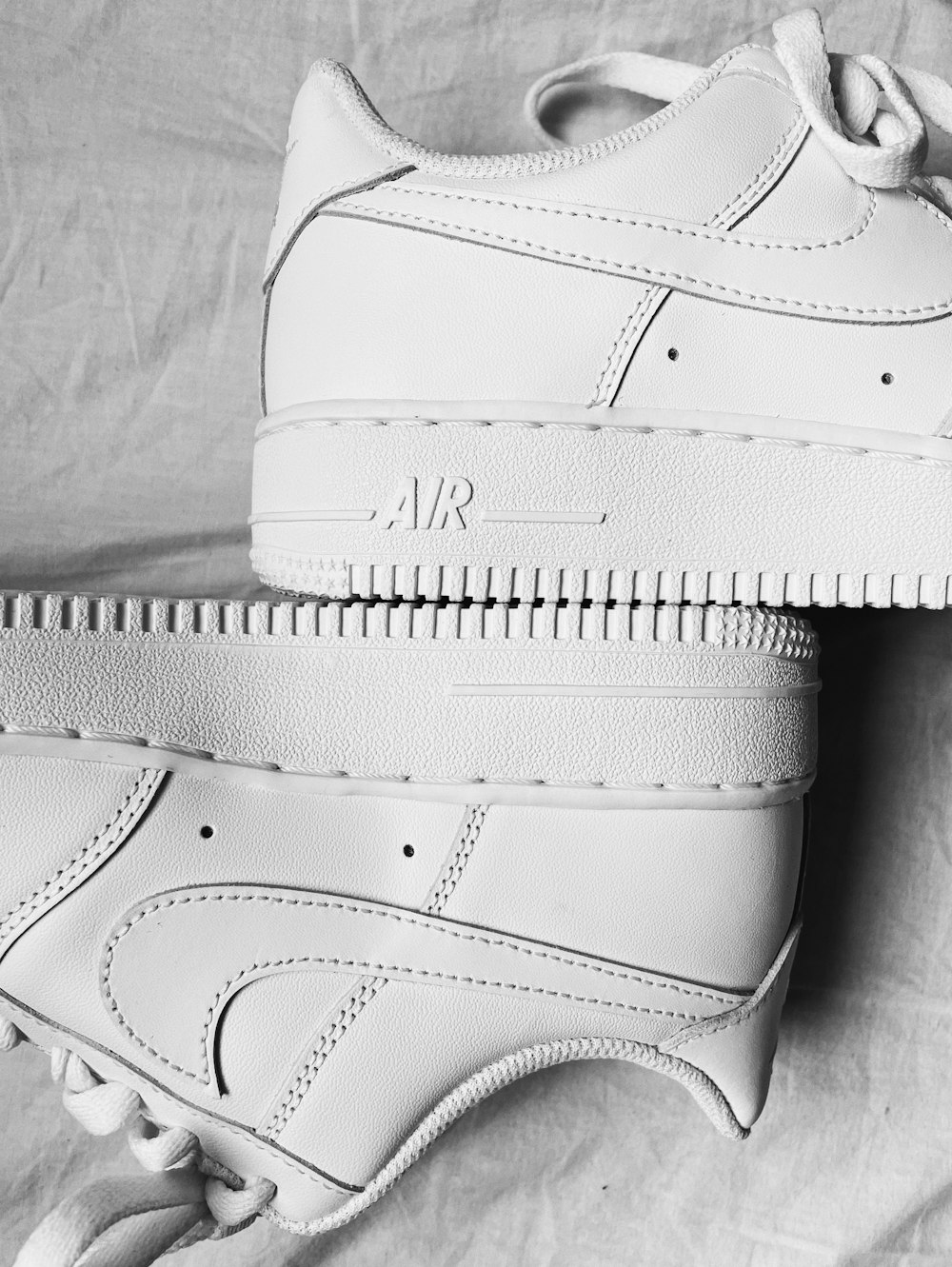 a pair of white nike air force sneakers