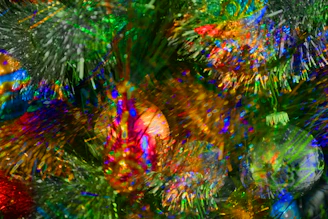 A vibrant display of assorted holiday decorations including colorful baubles, ribbons, and festive party accessories.