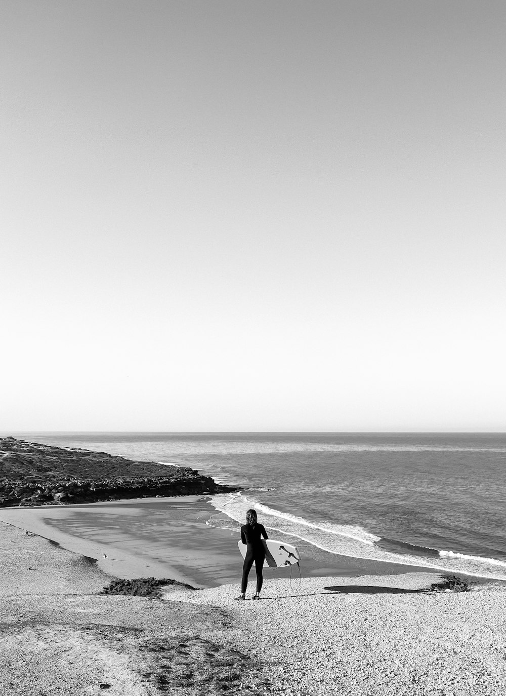 a person standing on a beach next to the ocean