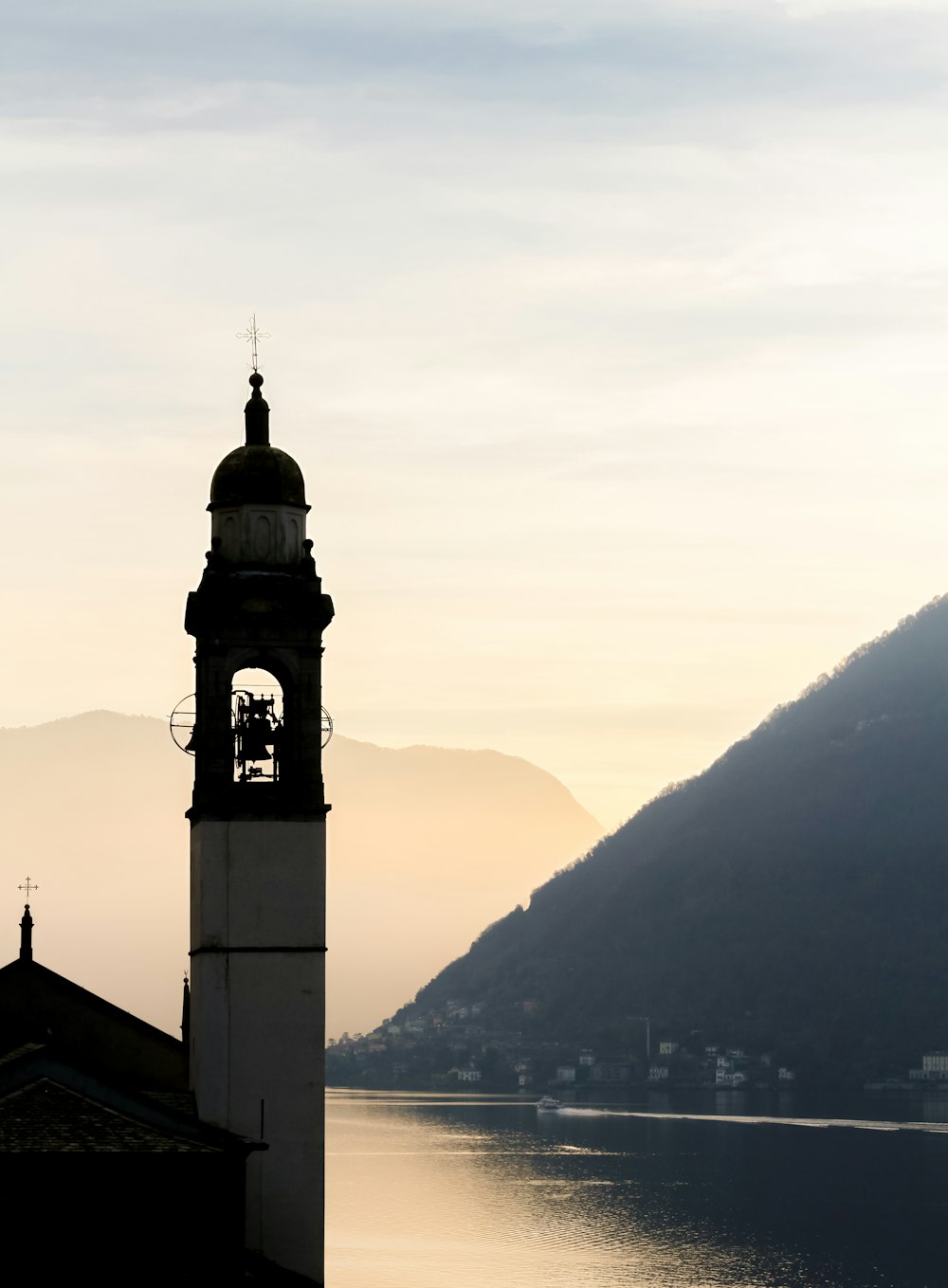 a clock tower with a bell on top of it