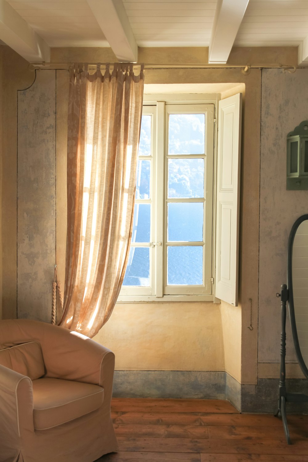 a living room with a chair and a window