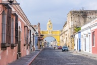 a city street with a clock tower in the background