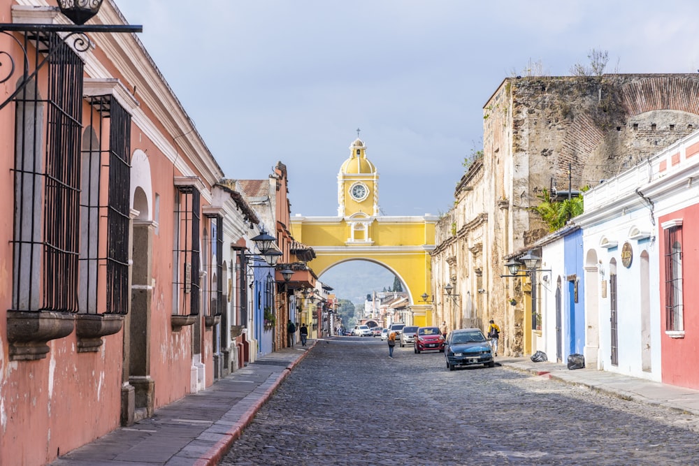 a city street with a clock tower in the background