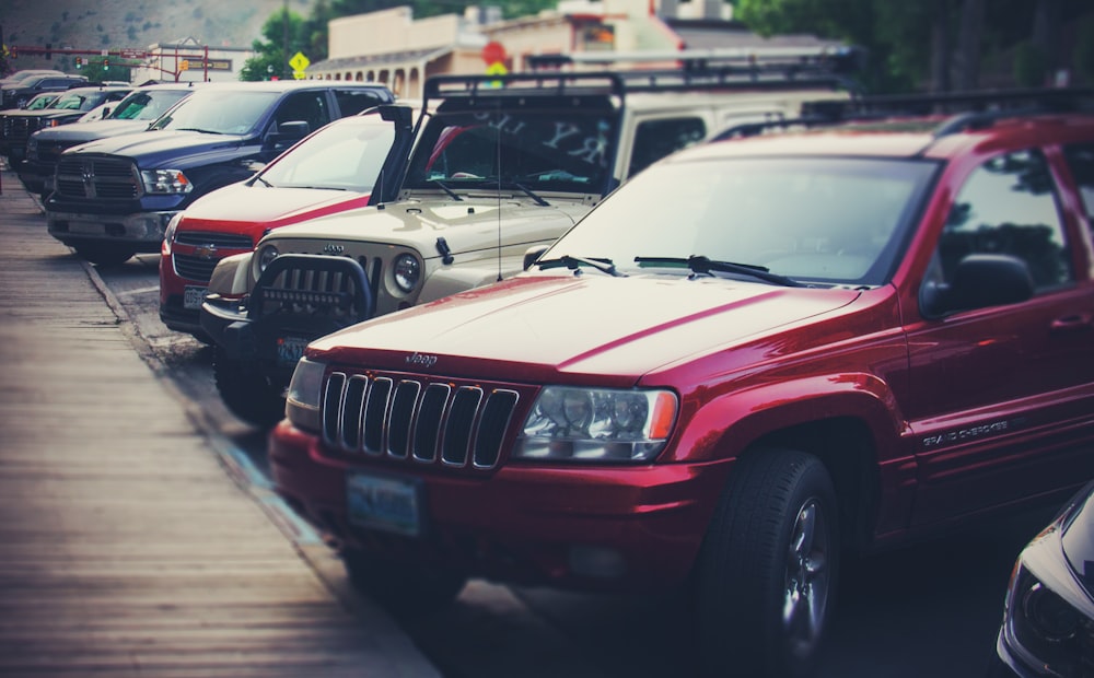 a row of parked cars sitting next to each other