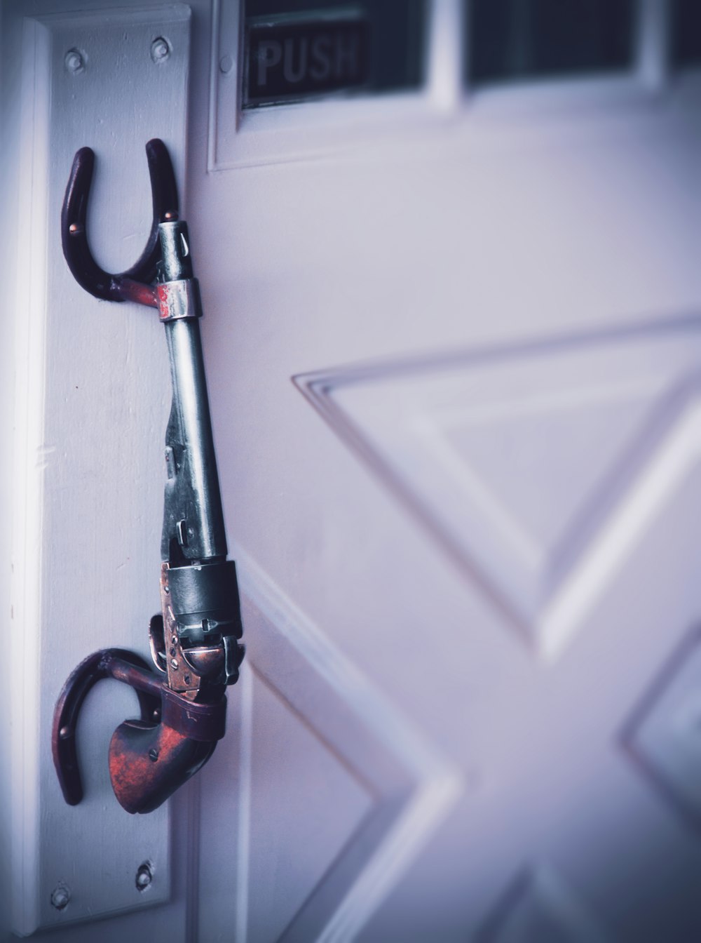 a pair of scissors hanging on a door handle