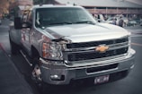 a silver truck parked on the side of the road