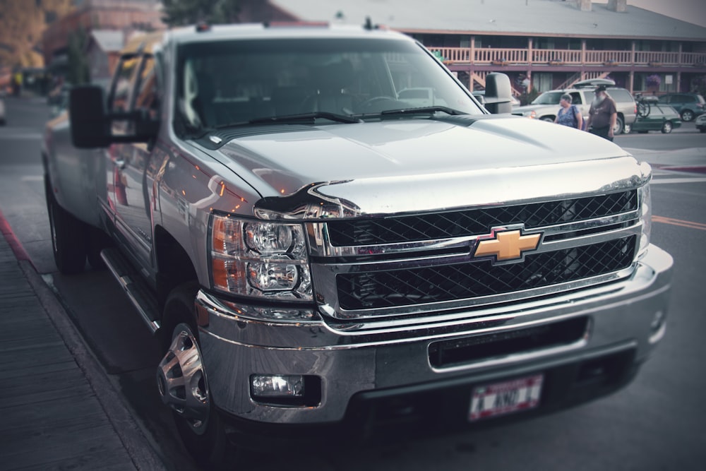 a silver truck parked on the side of the road