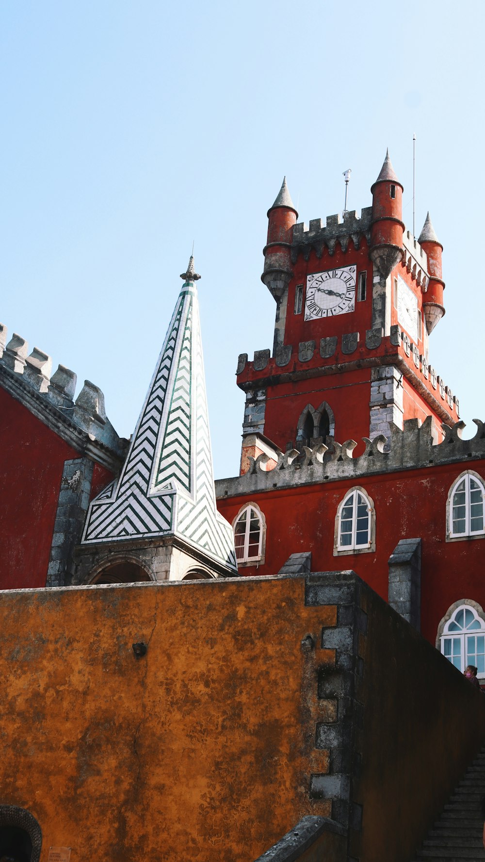 a large red building with a clock on it's side