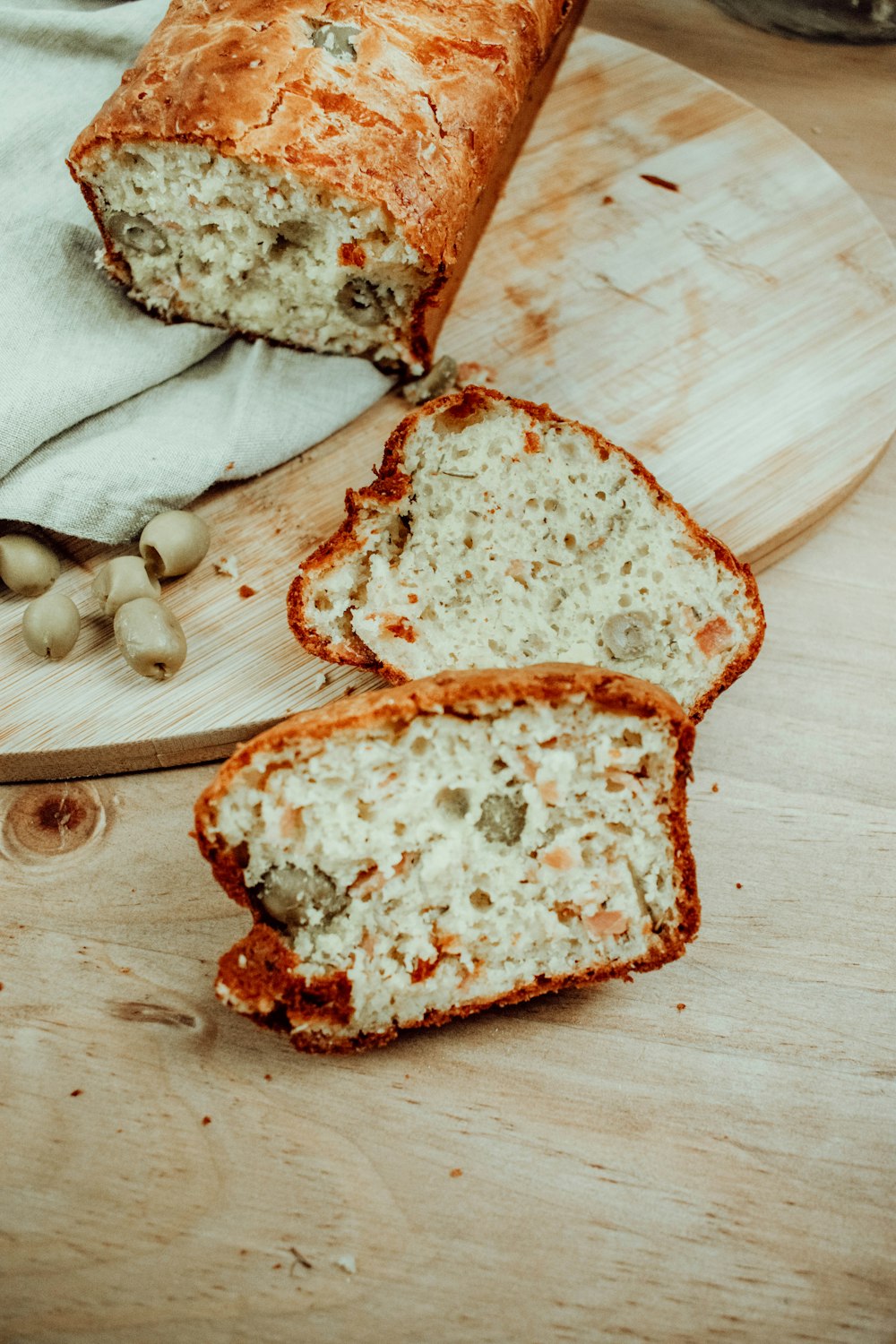 a loaf of bread sitting on top of a wooden cutting board