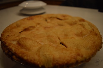 Close-up of a golden-brown crusted pie fresh from the oven, steam gently rising.