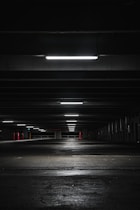 an empty parking garage at night with lights on