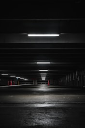 an empty parking garage at night with lights on