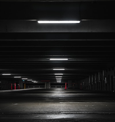 an empty parking garage at night with lights on