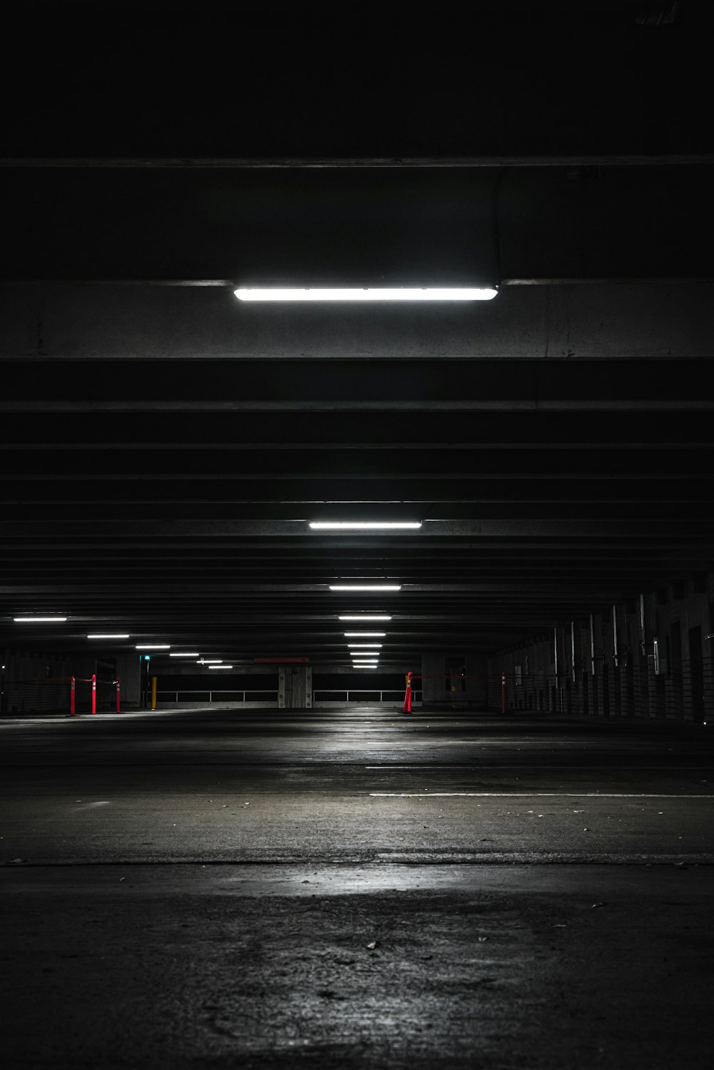 an empty parking garage at night with lights on