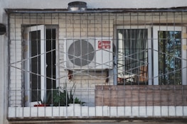 an air conditioner sitting on the side of a building