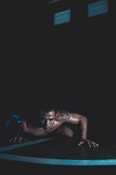 a man is doing push ups on a mat