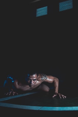 a man is doing push ups on a mat