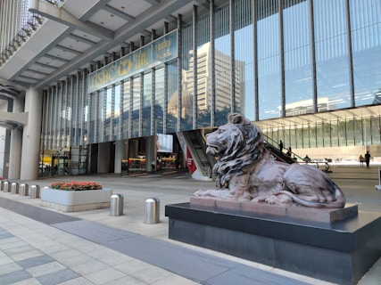 a statue of a lion in front of a building