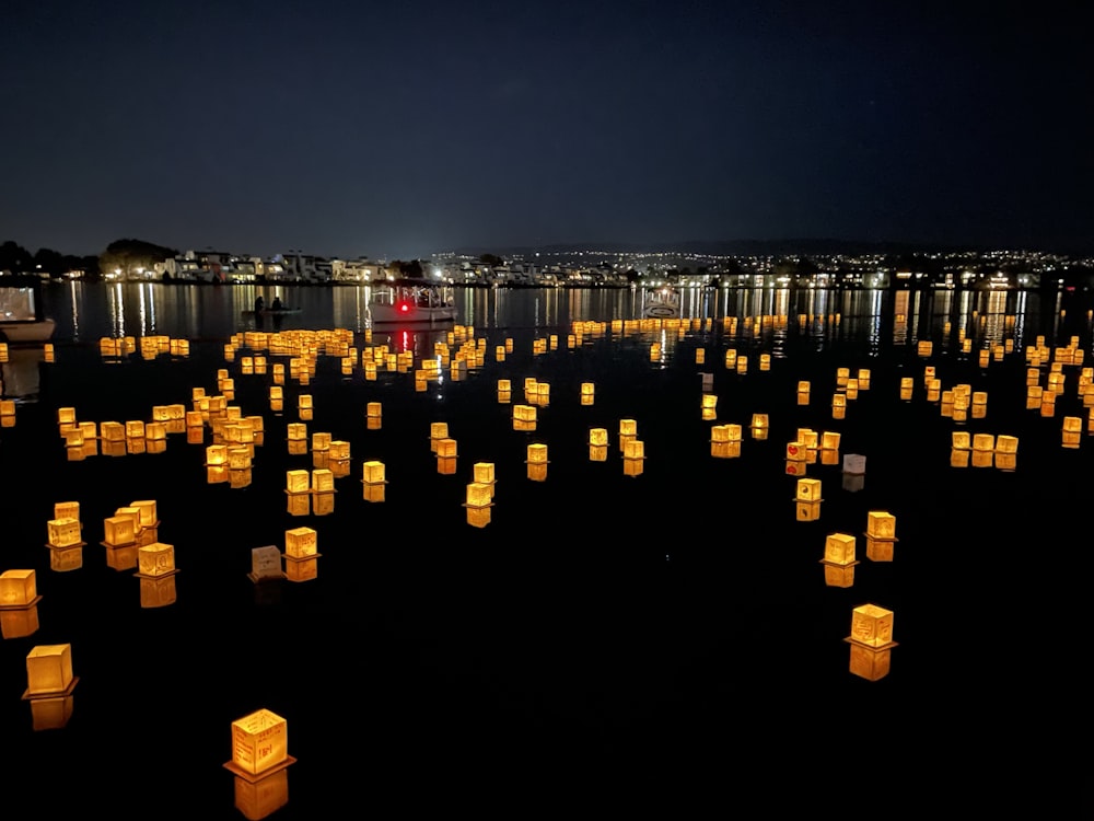 a large number of lanterns floating in the water