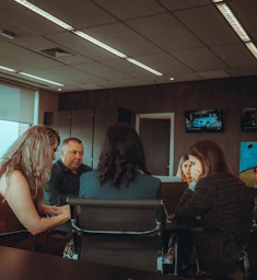 a group of people sitting around a table