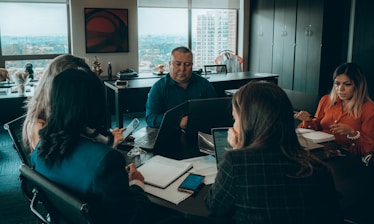 a group of people sitting around a table