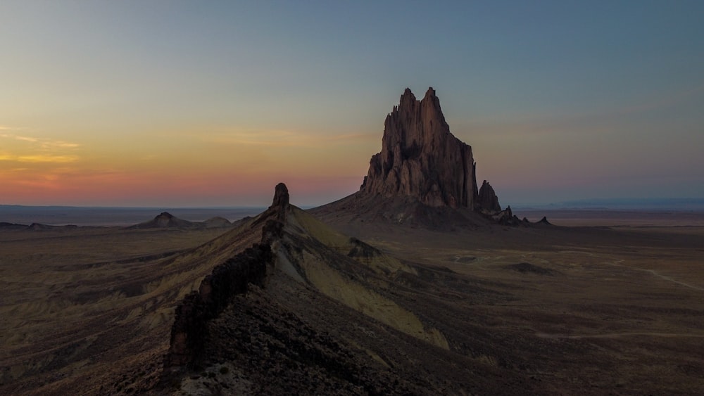 a mountain with a very tall rock formation in the middle of it