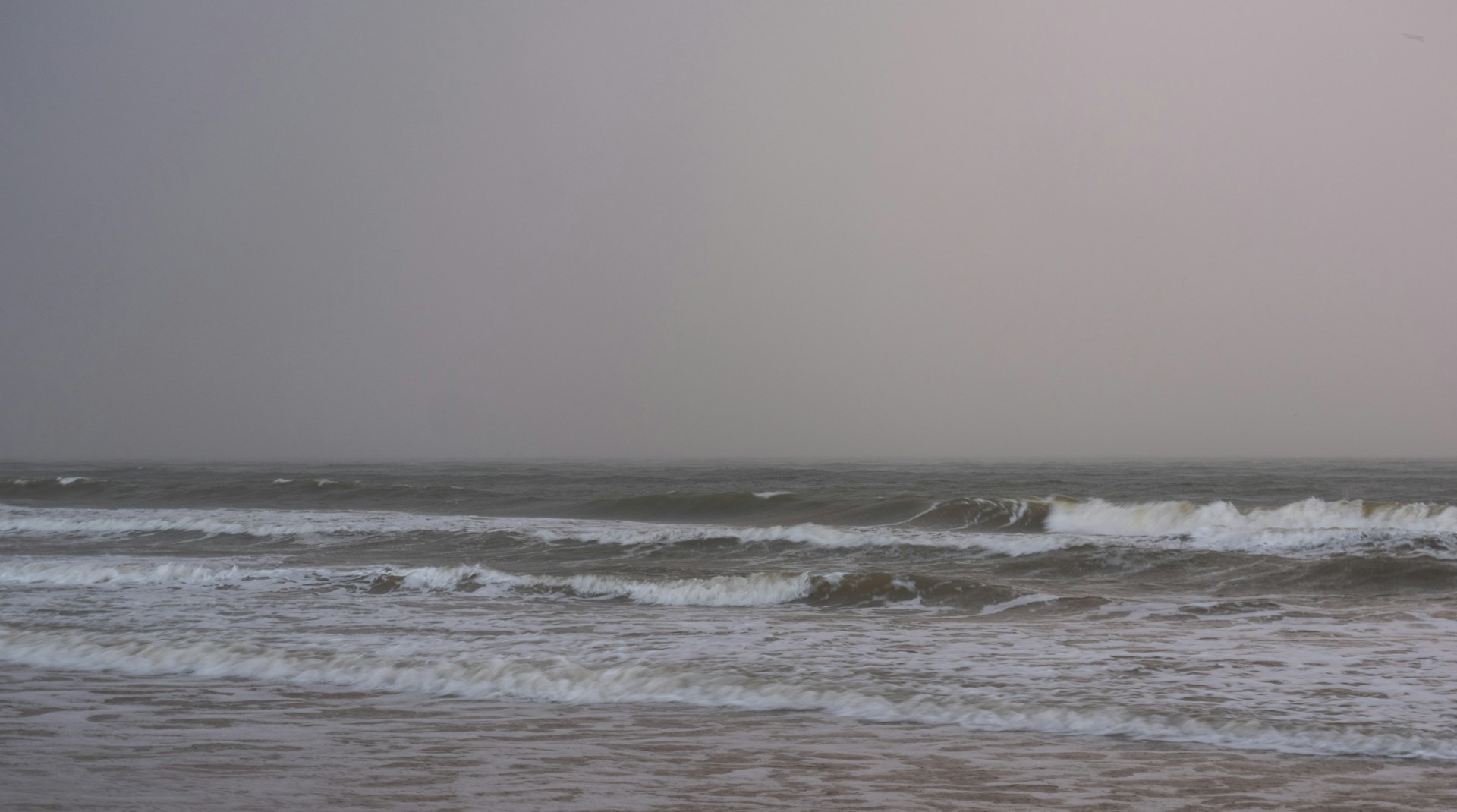 a person standing on a surfboard in the ocean