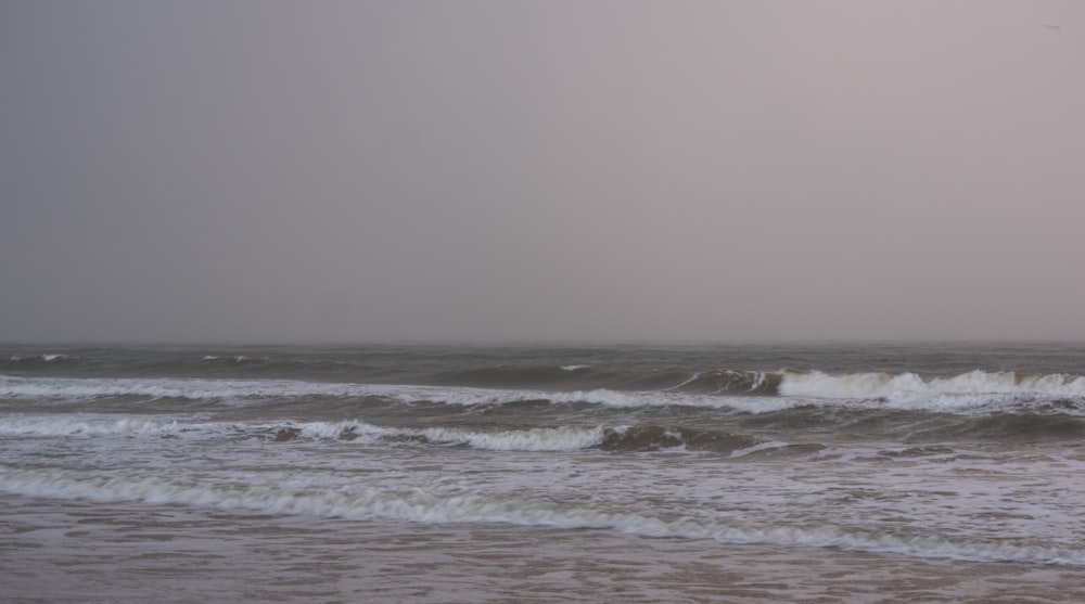 a person standing on a surfboard in the ocean