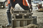 African woman adjusting her protective gloves on a construction site