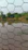 Close-up of galvanized wire mesh gabion being installed on a riverbank for erosion control.