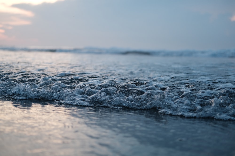 a close up of a wave on the beach