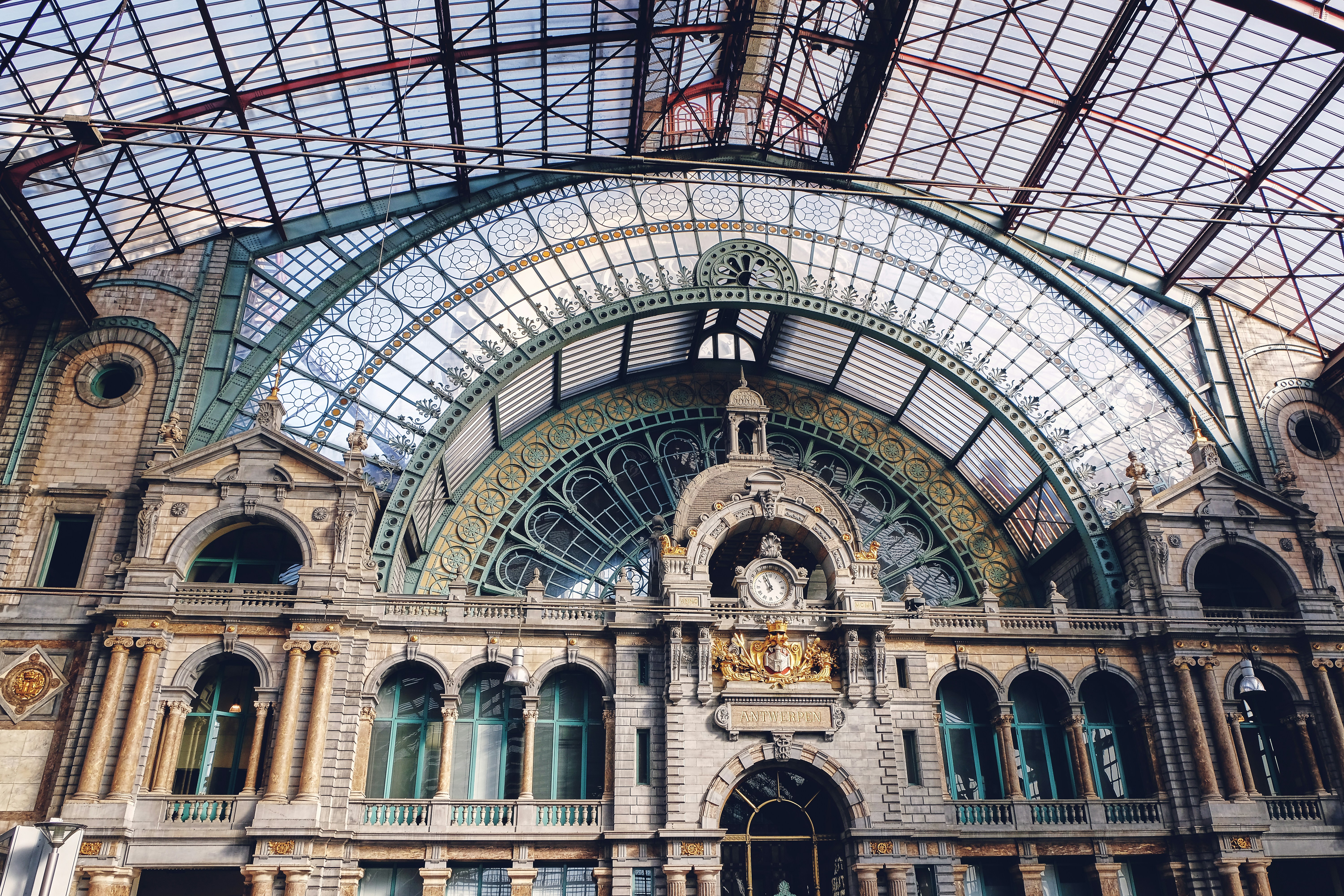 the inside of a train station with a glass ceiling, Antwerp Central Railway Station, awarded the first place for the most beautiful railway station in the world by Mashable magazine in 2014