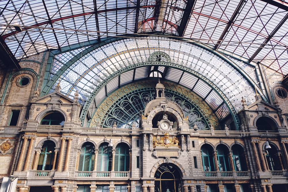 the inside of a train station with a glass ceiling