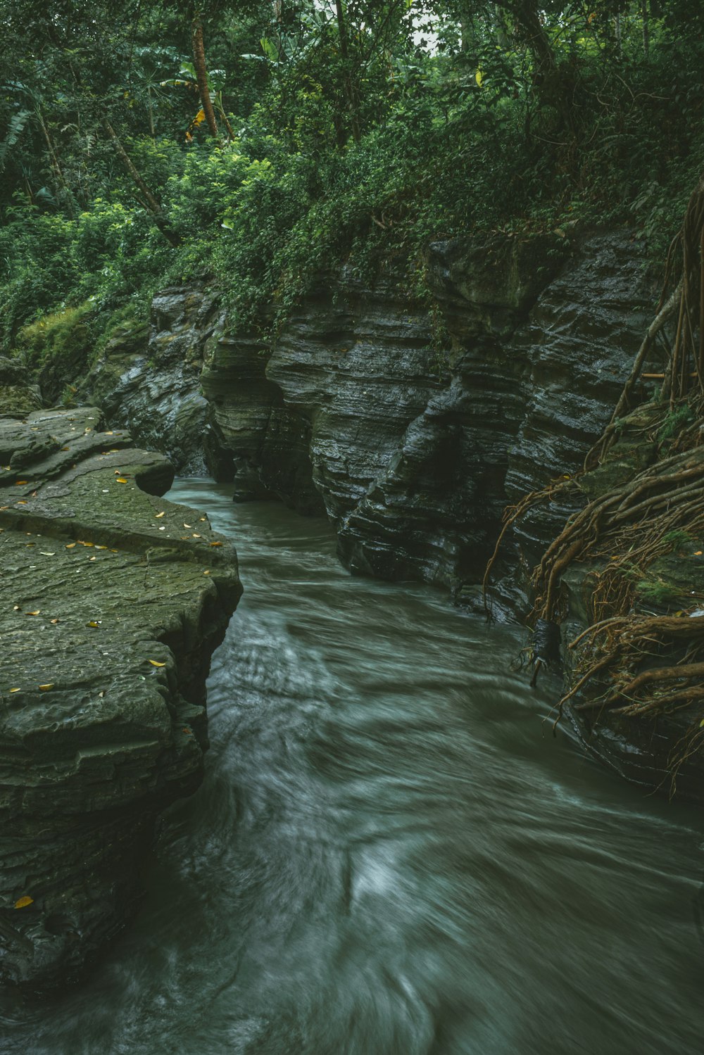 a large waterfall over some water with Starved Rock State Park in the background