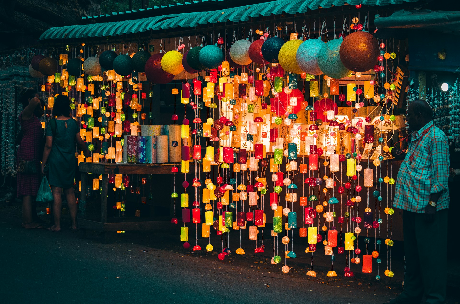 A vibrant scene showing a beautifully decorated wedding stall with traditional Indian fabrics and intricate jewelry pieces under warm festival lighting.