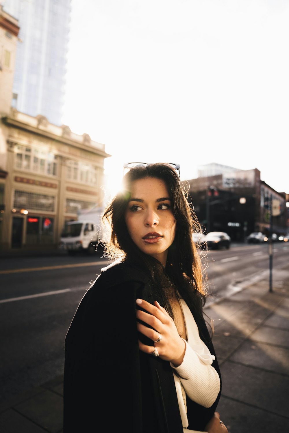 a woman standing on the side of a road