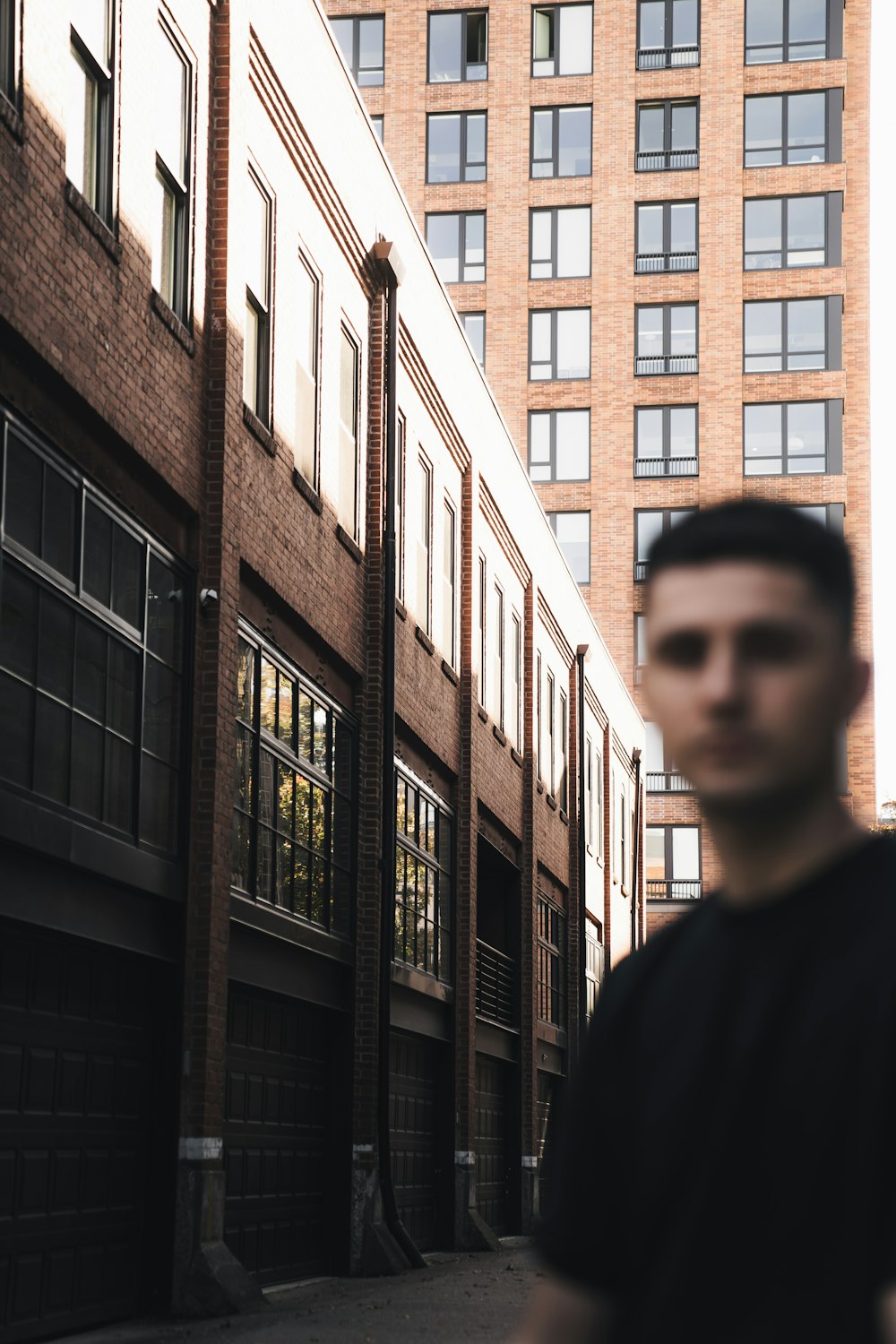 a man standing in front of a tall building