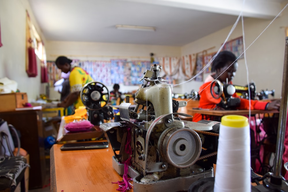 a sewing machine with a spool of thread next to it