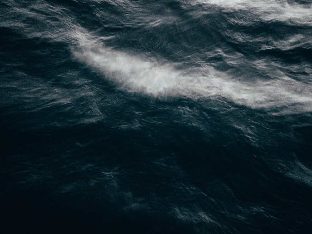 a large body of water with a boat in the middle of it