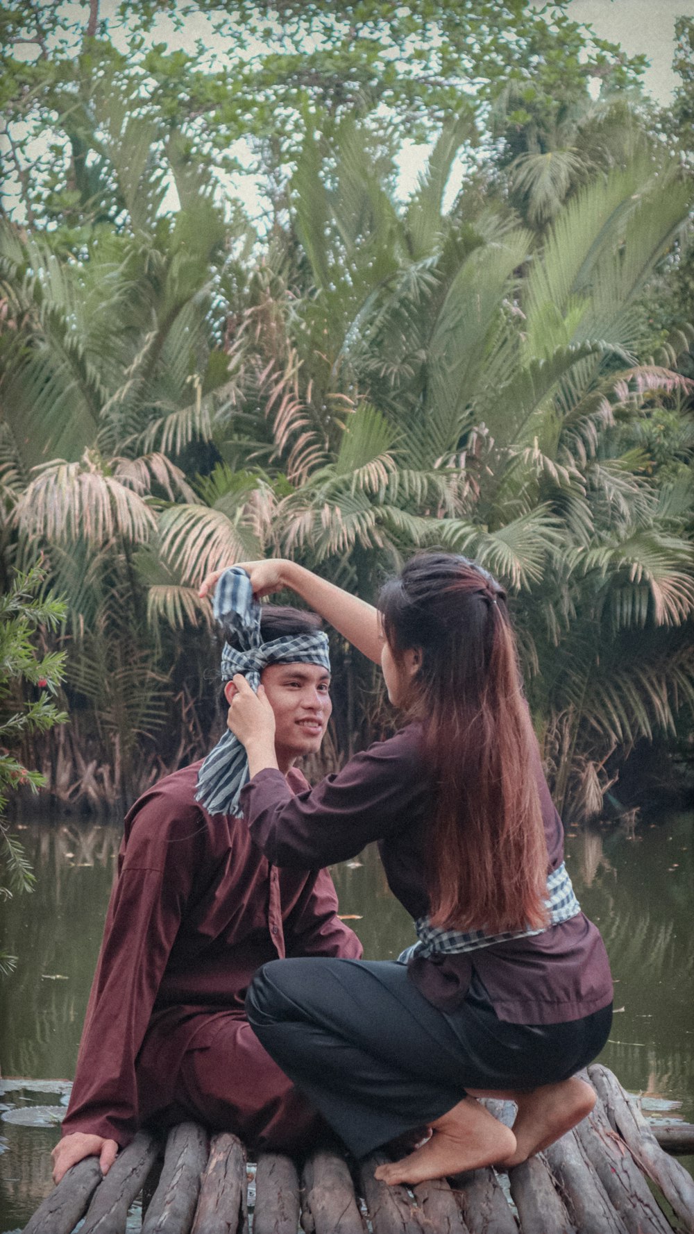 a couple of people that are sitting on a log