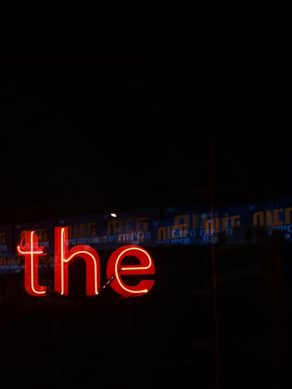 a neon sign that says the on the side of a building