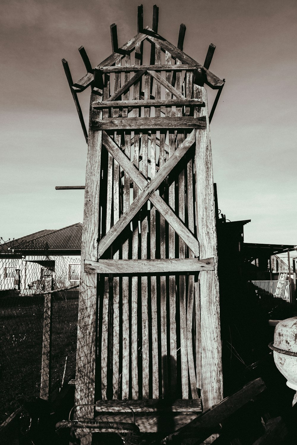 a tall wooden structure sitting in the middle of a field